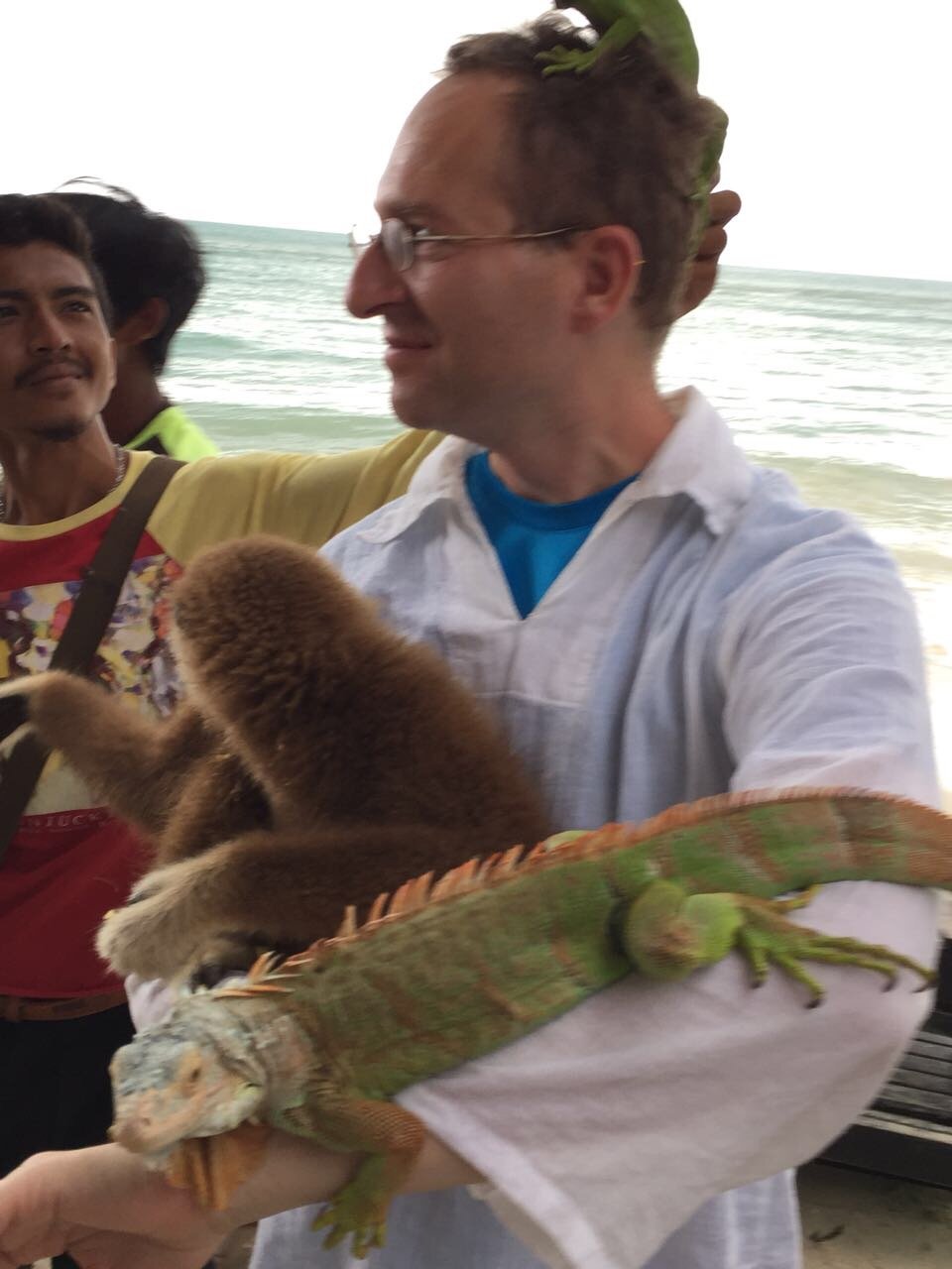 Dr. Mark Hosak with iguana in Thailand